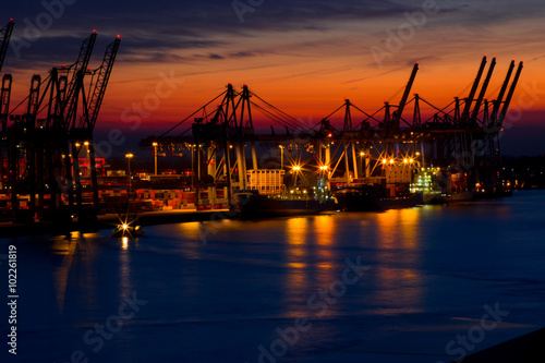 Harbor with cranes at night