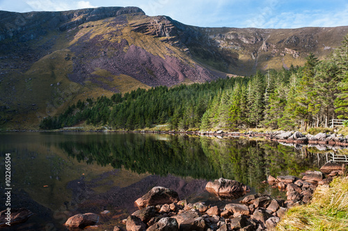 Wild landscape Lake reflection of Glentenassig Woods and Lake in north Kerry, Ireland