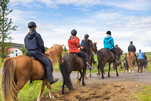 Group of horseback riders ride in Iceland