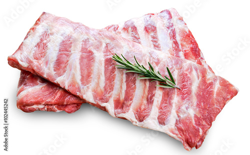 Raw Pork ribs with a rosemary isolated on white