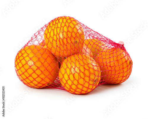 Fresh oranges in plastic mesh sack