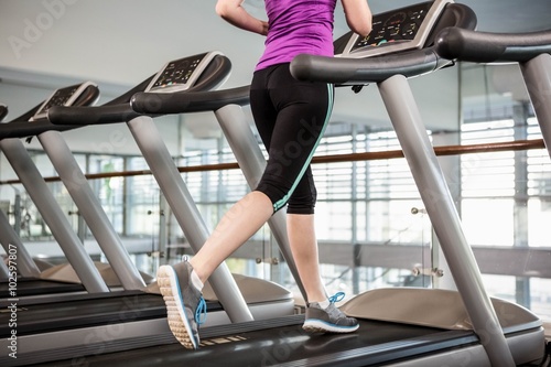 Lower section of fit woman on treadmill
