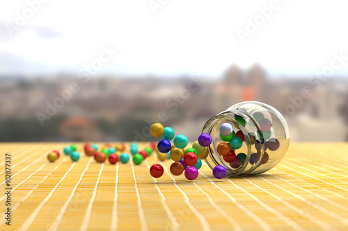 Colorful candies scattering out of glass jar