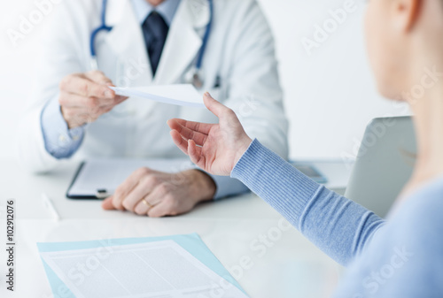 Doctor giving a medical prescription to the patient