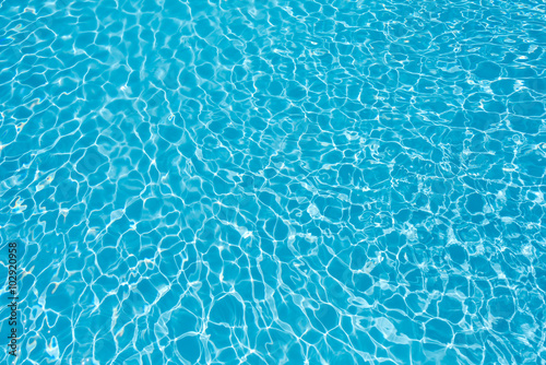 Ripple water surface and sun reflection in swimming pool