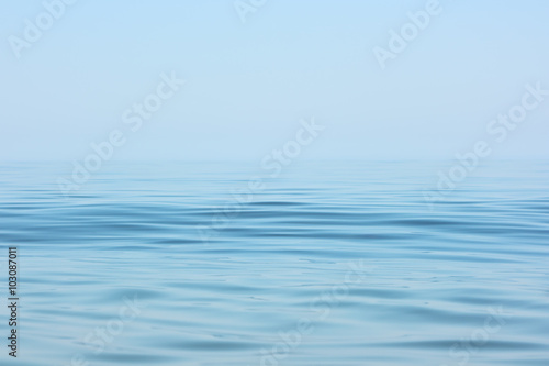 Calm sea surface. Seascape in early morning hours under clear skies.