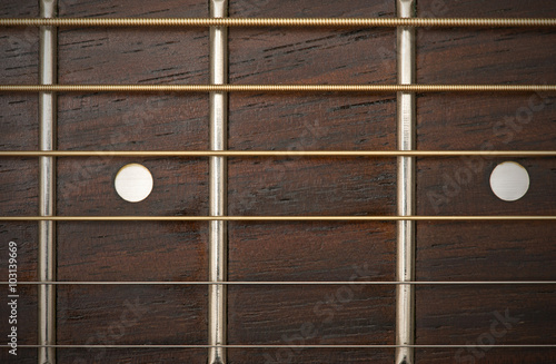 close-up macro of guitar strings and fret board 