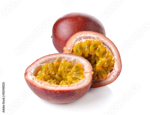 whole and half cut passion fruits on white background