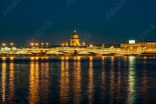 View of English embankment, St. Isaac's Cathedral and Annunciation bridge in St. Petersburg with night illumination