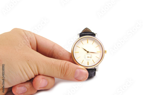 Close up of hand holding watch, isolated on white background. Time concept