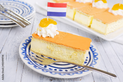 Orange tompouce, traditional Dutch pastry, on a rustic table