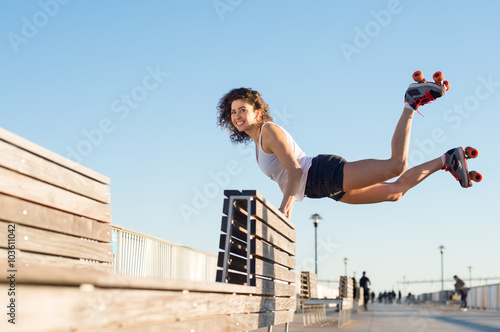 Woman jumping with roller skates