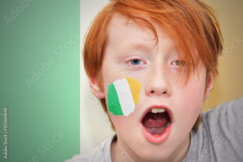 redhead fan boy with irish flag painted on his face