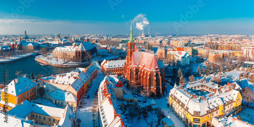 Aerial scenic panorama of Old Town and Ostrow Tumski with church of the Holy Cross and St. Bartholomew from Cathedral of St. John in the winter morning in Wroclaw, Poland