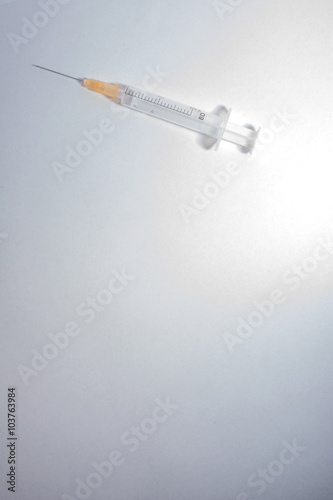 syringe on a light background vertically