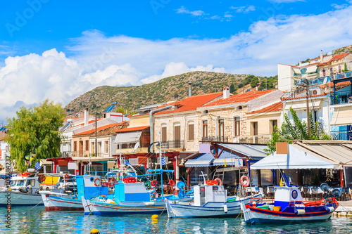 Colorful houses in Pythagorion port full of fishing boats, Samos island, Greece