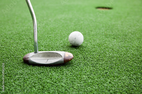Close-up of golfer playing a golf in green grass field