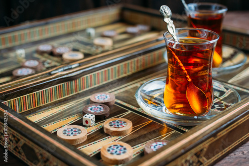 Turkish sweets and tea on the backgammon Board