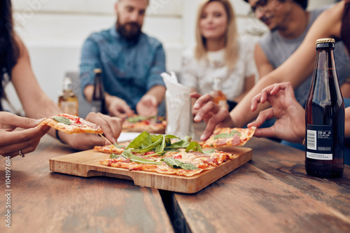 Friends partying and eating pizza