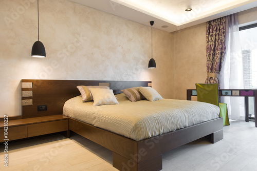 Double bed in modern bedroom interior