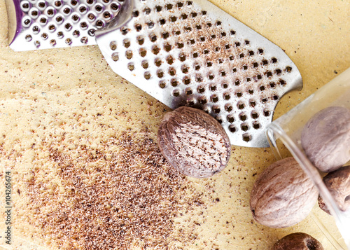 nutmeg with grater over paper