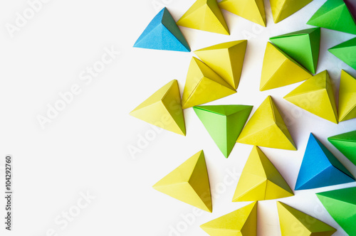 Origami pyramids background. Futuristic polygonal composition with copy space on the left side.
