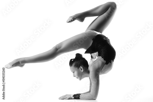 young sporty woman doing acrobatic exercise