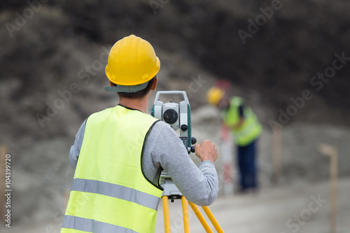 Workers with theodolite