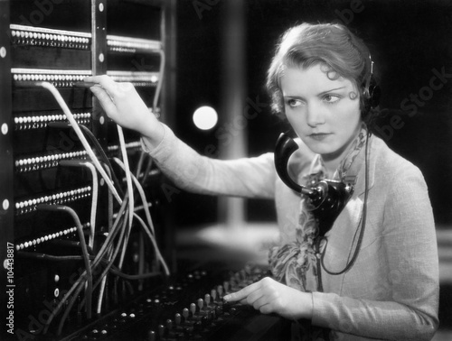 Young woman working as a telephone operator 