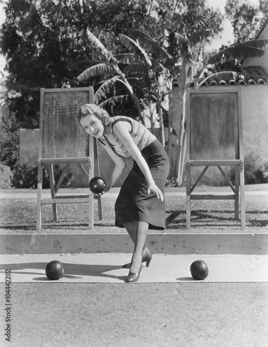 Woman playing bocce outdoors 