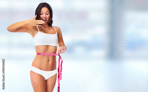 Woman with measuring tape over blue background.