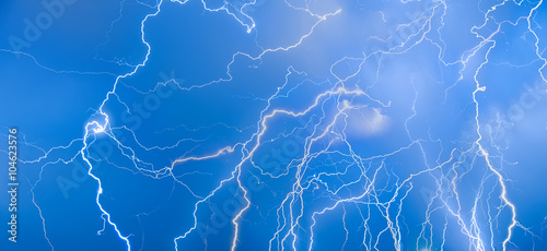 Flashes of lightning on a blue sky. Background