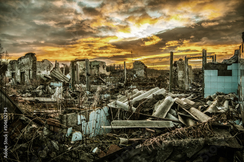 Apocalyptic landscape.The remains of destroyed houses at sunset