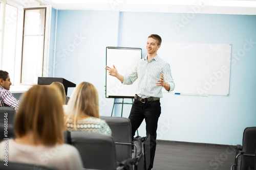 Businessman giving a presentation on flipchart. Teamwork concept