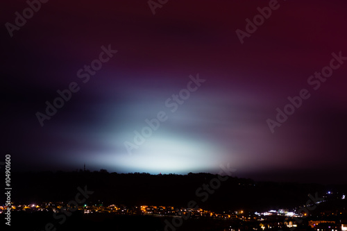 Light pollution from sports fields. A rainy night shows light from university pitches at night, above the City of Bath, UK