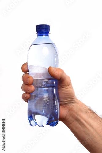 Mano sujetando una botella de agua mineral en fondo blanco.