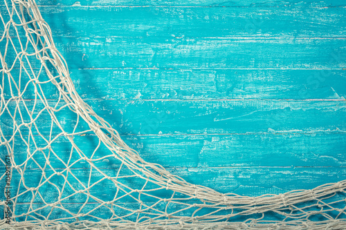Fishing net on old blue board
