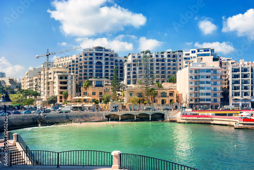 Cityscape with Spinola bay, St. Julians in sunny day, Malta.