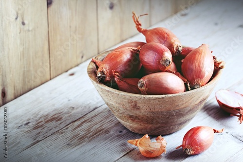 Shallot on a rustic wooden table.Selective focus