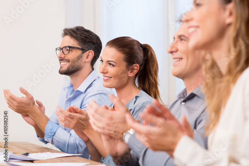 Business people clapping hands