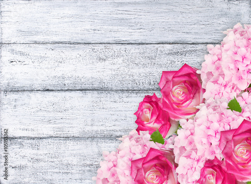 Roses and hydrangeas on shabby wooden planks