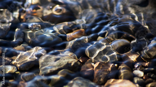Pebbles in shallow water Siberian river
