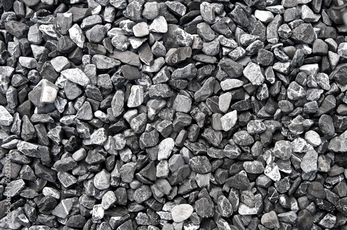 Pattern grey gravel granite texture background for mix rock concrete pattern in construction industrial. Small gray pebble on ground or floor. Vintage and retro. Close up.