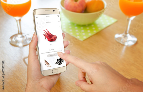 Online shopping with smart phone. Isolated phone in woman hand. Buying women shoes on online store.