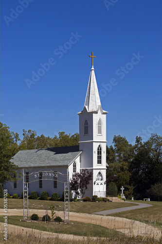 White church, steeple, and footbridge