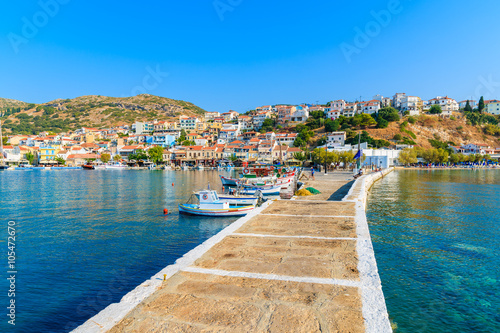 Pier in Pythagorion port with fishing boats in distance, Samos island, Greece