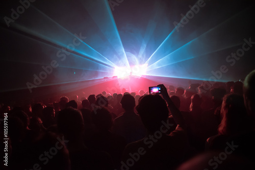 Phone in the air at a music concert in a dance club