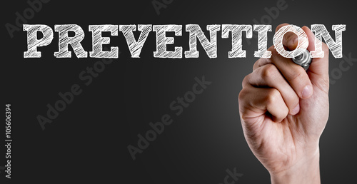 Hand writing the text: Prevention