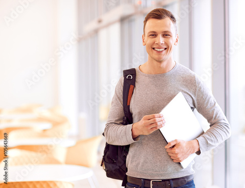 Pleasant student holding folder