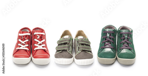 Three pairs of childrens colorful shoes